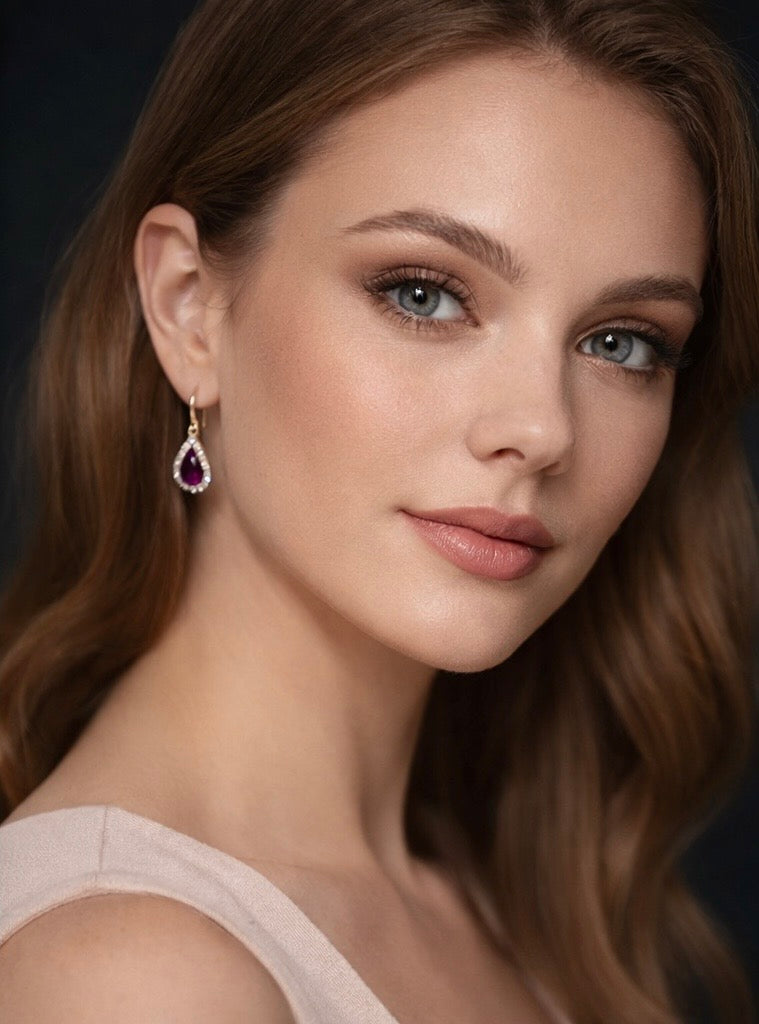 Close-up of a woman wearing a pair of ruby and diamond earrings with a dark background by SommerSparkle