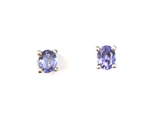 Tanzanite Sterling Silver Stud Earrings, An alluring and delightful pair of stud earrings created with 0.680 carats of tantalising Tanzanite of grade AA quality, in an oval design, set upon solid sterling silver earrings